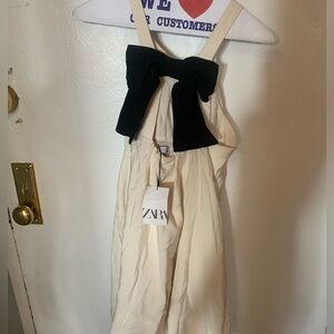 White dress with a black bow from Zara